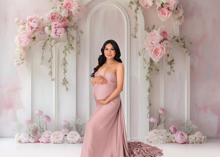 maternity photo of a woman holding her belly by newborn photos by catalina